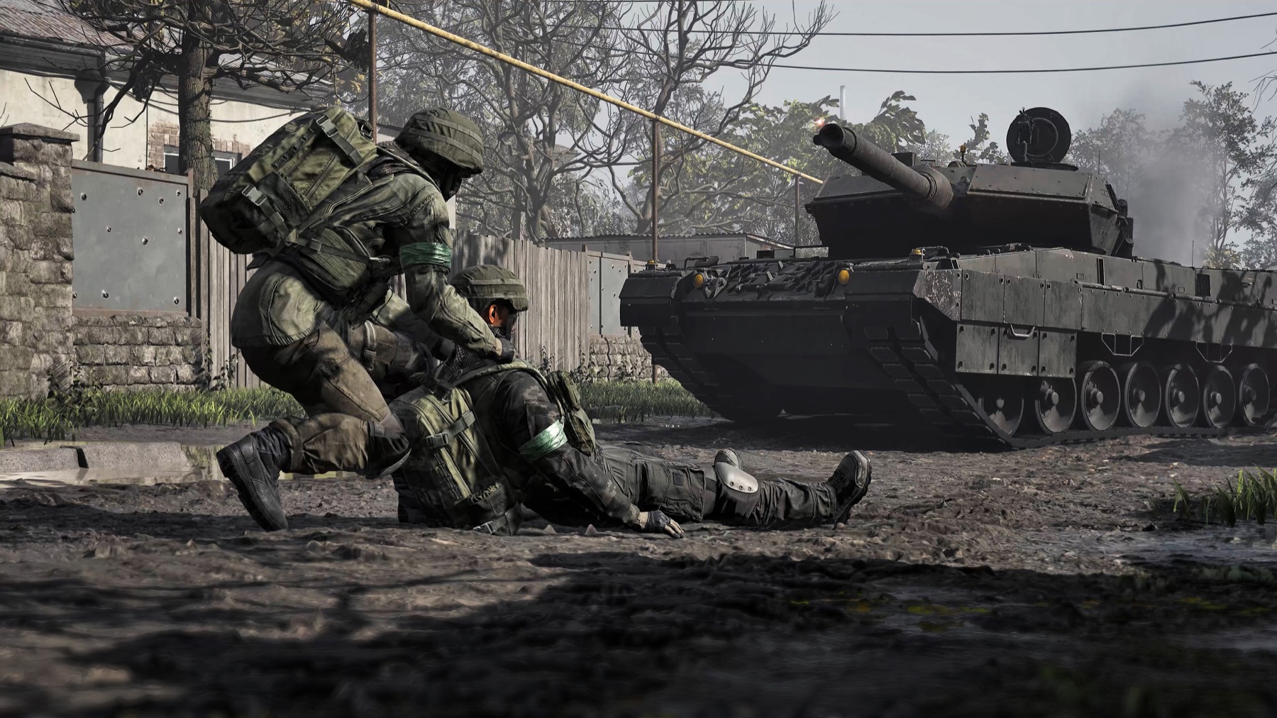A medic drags a wounded soldier past a tank